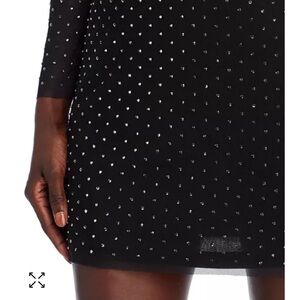 Rhinestone studded mini dress. Mock neck and pull on. Fits slim.
